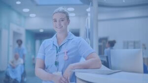 smiling female nurse in hospital foyer